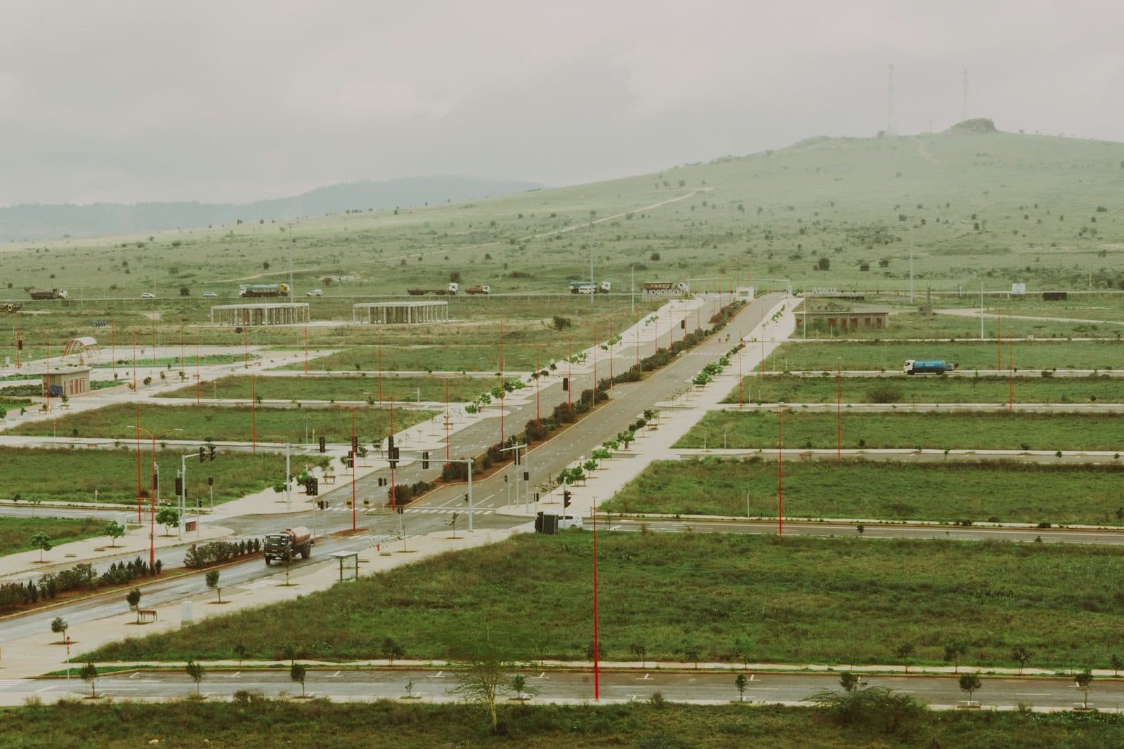 Newly marked building plots with access roads across a grassy hillside