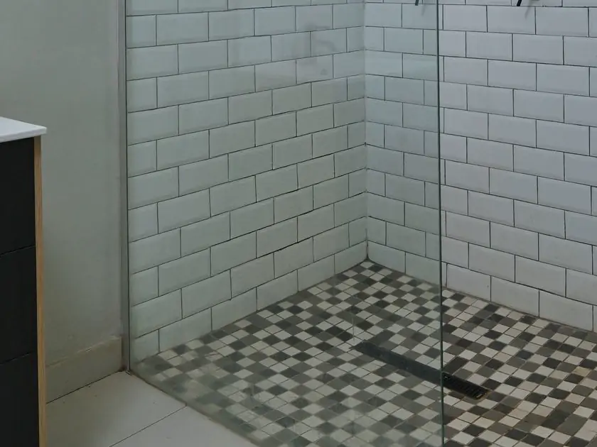 Bathroom 2: the floor. The shower floor's small gray and white tiles and the drain (sample photo)