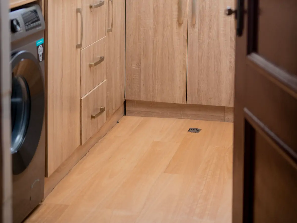 Kitchen: the floor. The wooden floor between the cabinets and the washing machine (sample photo)
