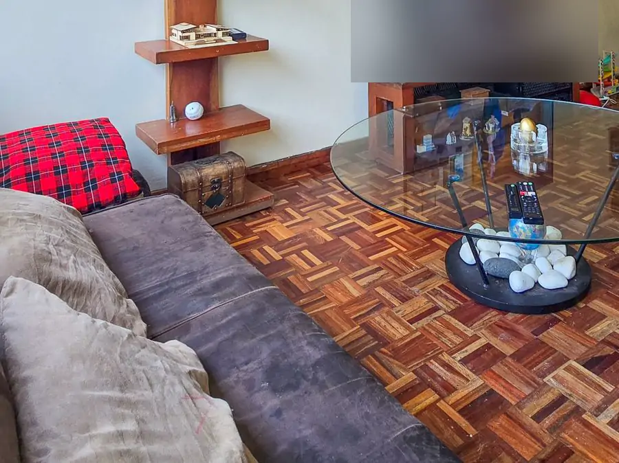 Living or dining room: the floor. The wooden parquet floor by the sofa and the coffee table (sample photo)